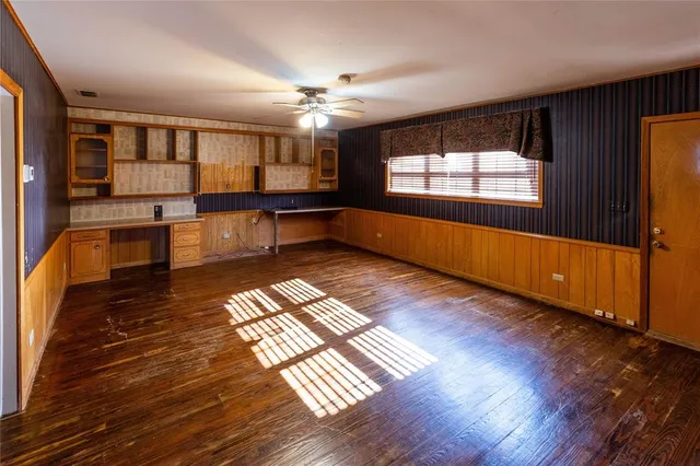 a view of a room with wooden floor and window