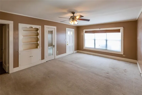 a view of livingroom with a ceiling fan and window