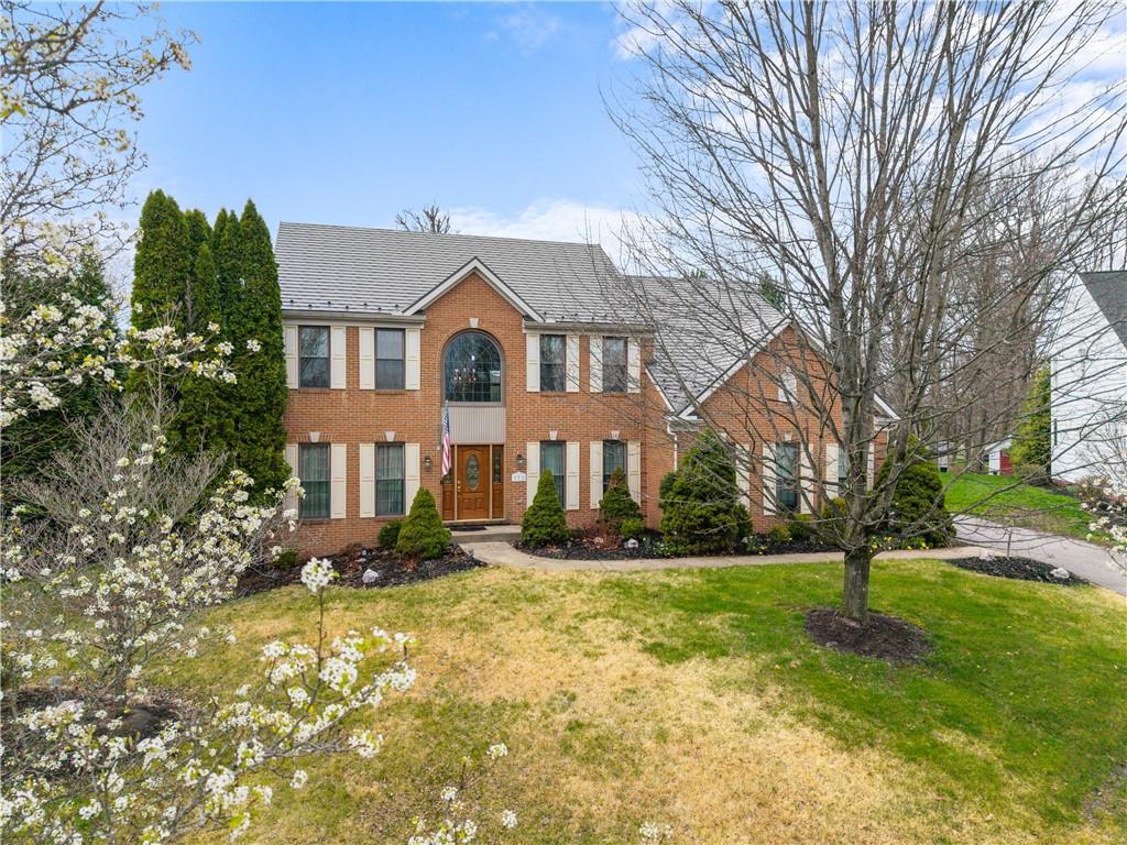 a front view of a house with a yard