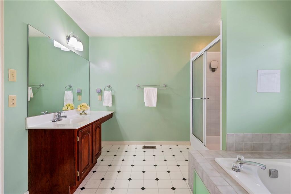 372 Indian Ridge Drive Coraopolis, PA 15108 - Photo 18 of 30 a bathroom with a sink a toilet a shower and a mirror