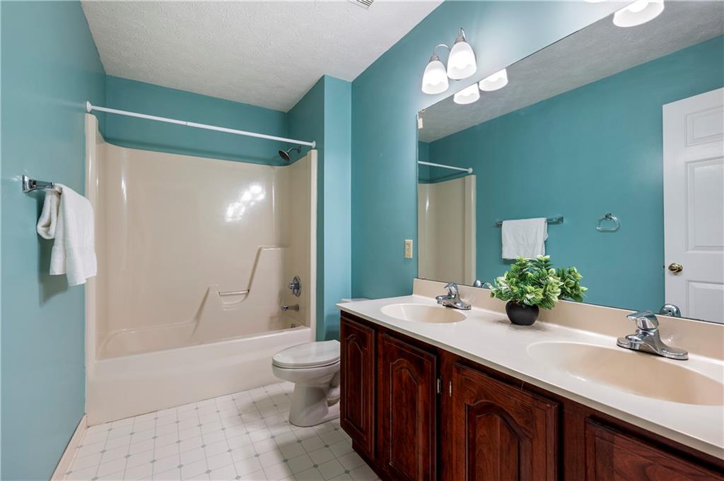 372 Indian Ridge Drive Coraopolis, PA 15108 - Photo 22 of 30 a bathroom with a double vanity sink toilet mirror and shower