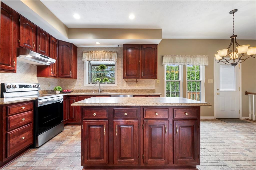 372 Indian Ridge Drive Coraopolis, PA 15108 - Photo 4 of 30 a kitchen with wooden cabinets and a sink