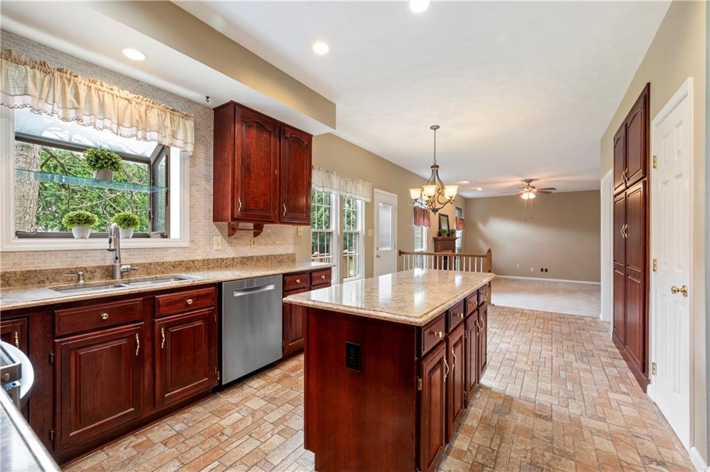 372 Indian Ridge Drive Coraopolis, PA 15108 - Photo 7 of 30 a kitchen with kitchen island granite countertop a sink stove and cabinets