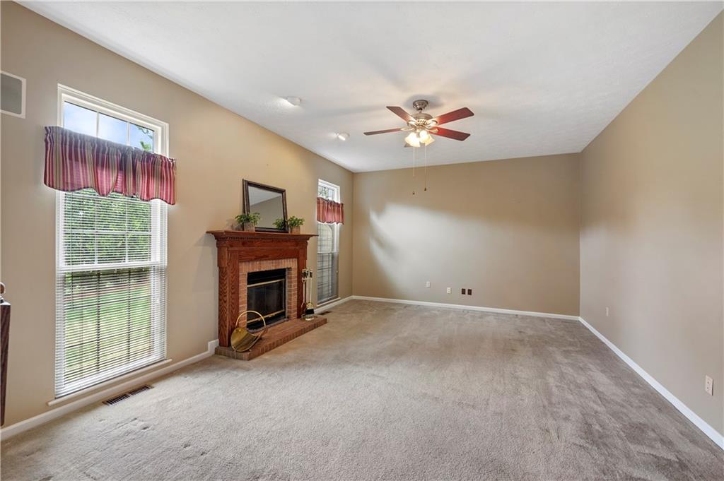 372 Indian Ridge Drive Coraopolis, PA 15108 - Photo 8 of 30 a view of a livingroom with a fireplace a ceiling fan and windows