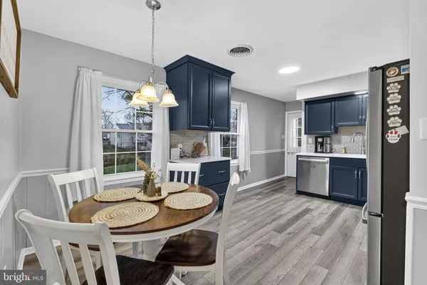 a kitchen with granite countertop a sink cabinets and refrigerator