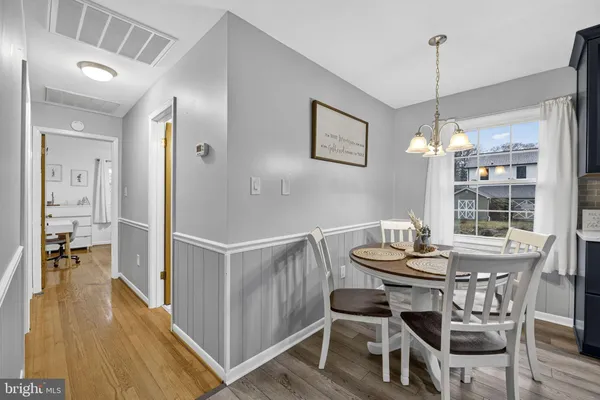 a dining room with furniture and wooden floor