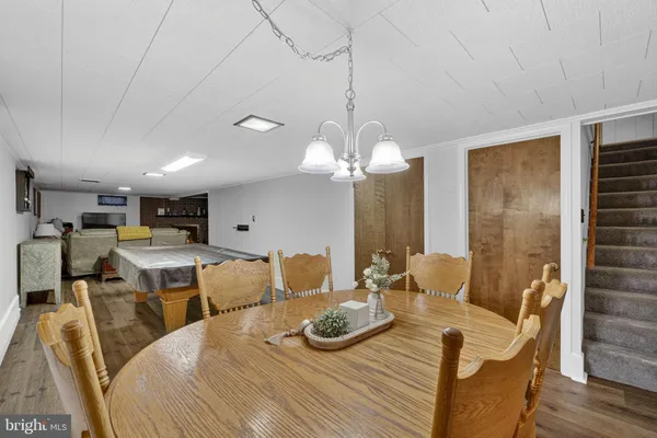 a dining room with furniture and wooden floor