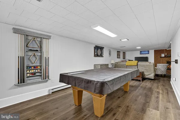 a living room with furniture a table and wooden floor