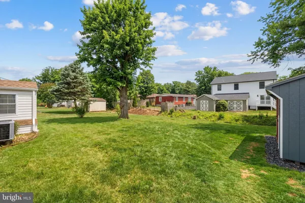 a front view of house with yard and trees