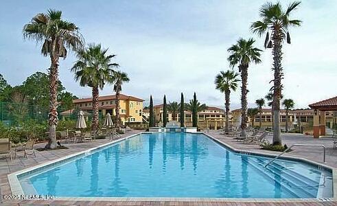 9745 Touchton Road, Unit 1103 Jacksonville, FL 32246 - Photo 25 of 29 a view of swimming pool with outdoor seating and palm trees