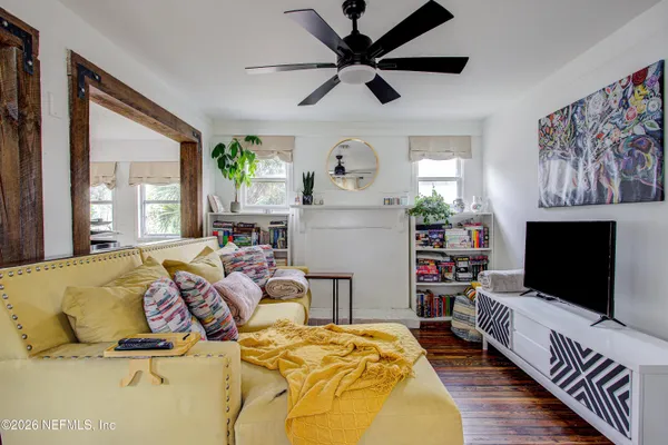 a living room with furniture and wooden floor