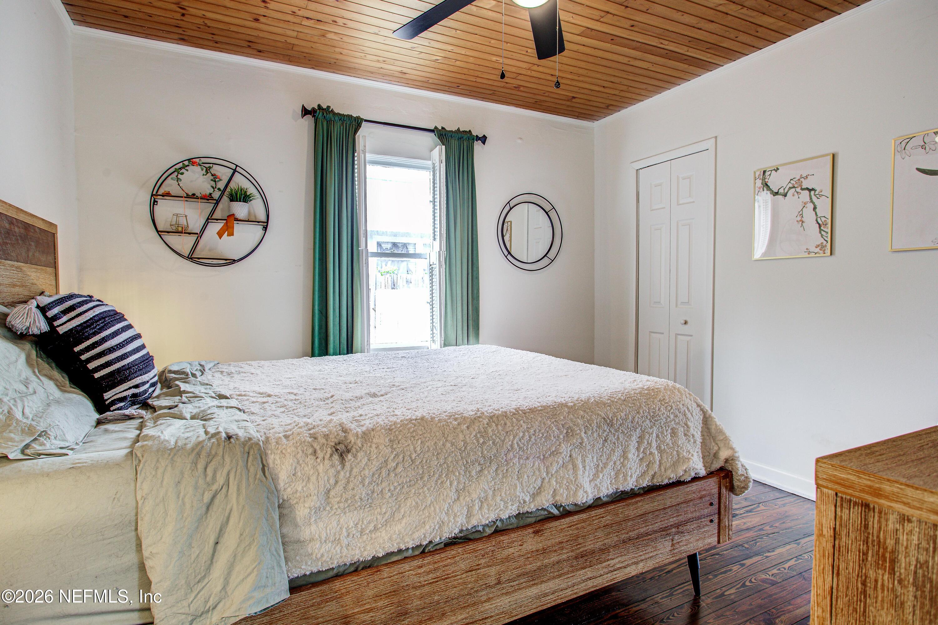 1441 Rensselaer Avenue Jacksonville, FL 32205 - Photo 15 of 33 a bedroom with a bed and a chandelier