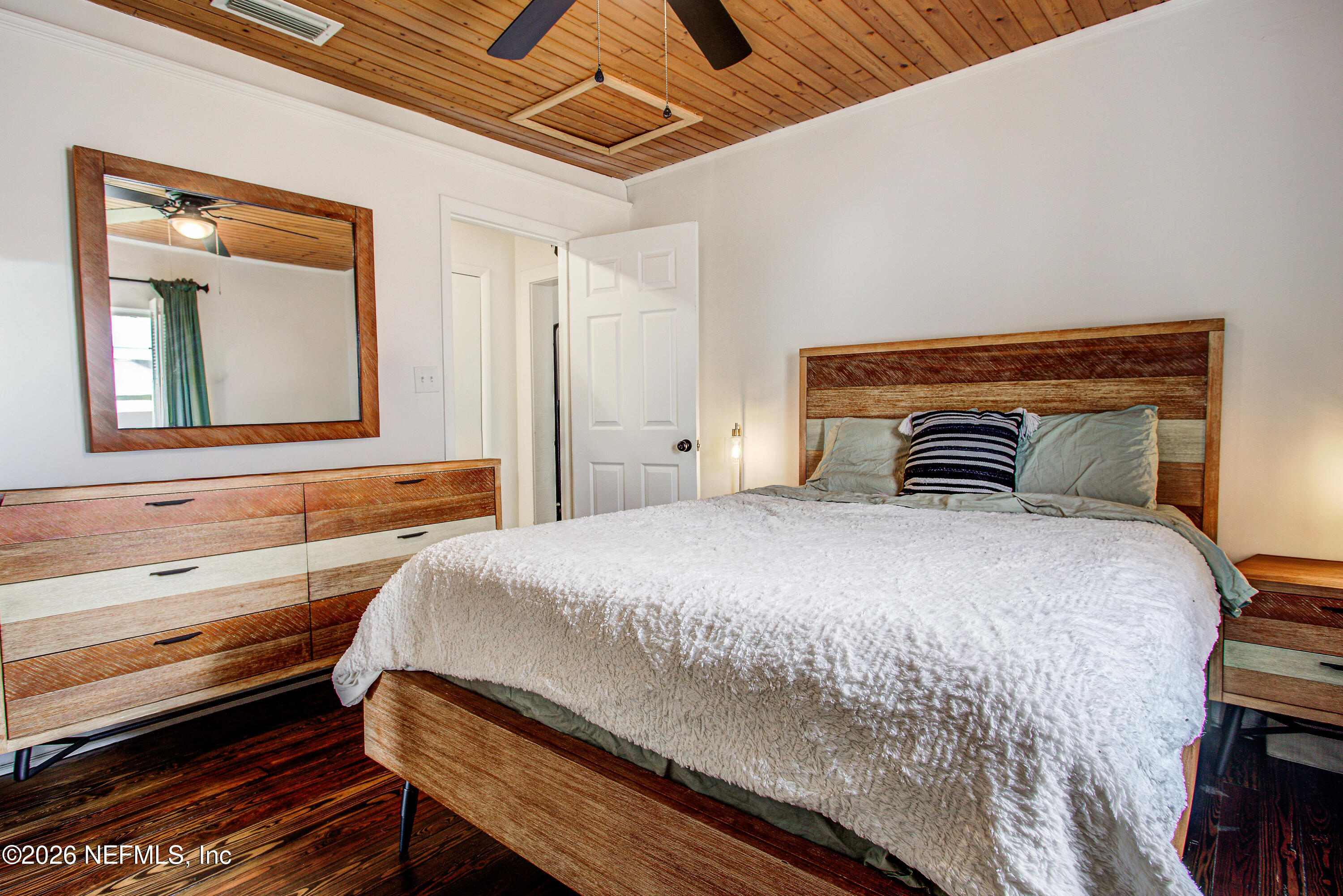 1441 Rensselaer Avenue Jacksonville, FL 32205 - Photo 16 of 33 a bedroom with a bed and wooden floor