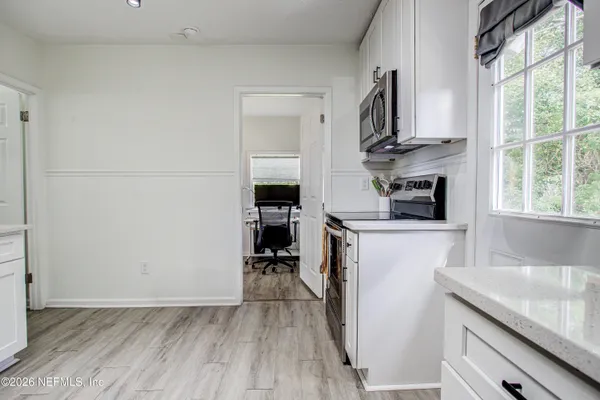 a kitchen with stainless steel appliances a sink stove refrigerator and cabinets