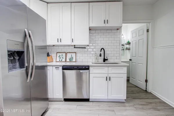 a kitchen with stainless steel appliances a stove microwave and a refrigerator