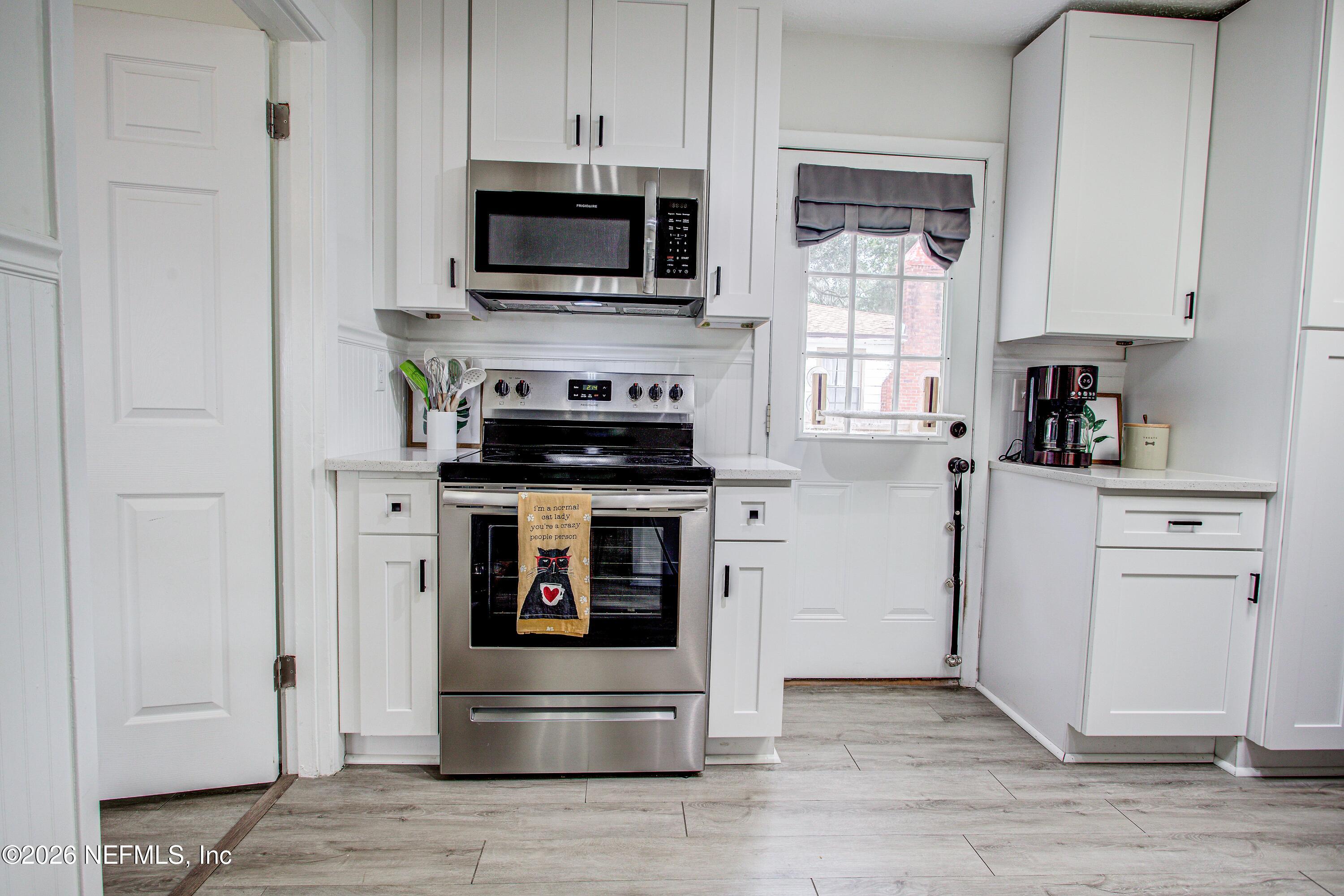 1441 Rensselaer Avenue Jacksonville, FL 32205 - Photo 19 of 33 a kitchen with stainless steel appliances a stove microwave and a refrigerator