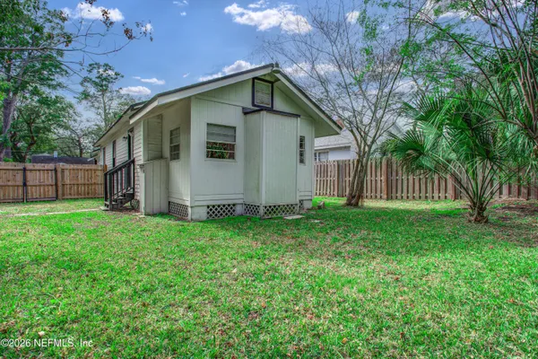 a view of a house with wooden fence
