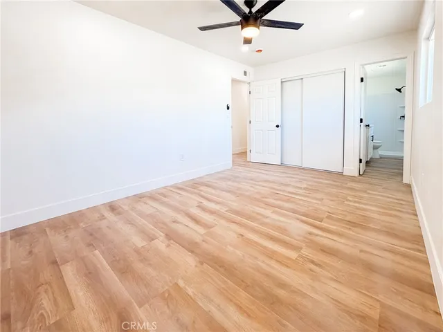 a view of a livingroom with a ceiling fan and window