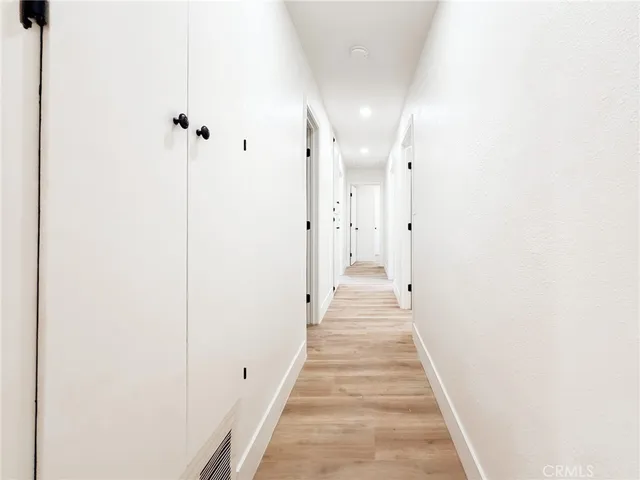 a view of a hallway with white walls