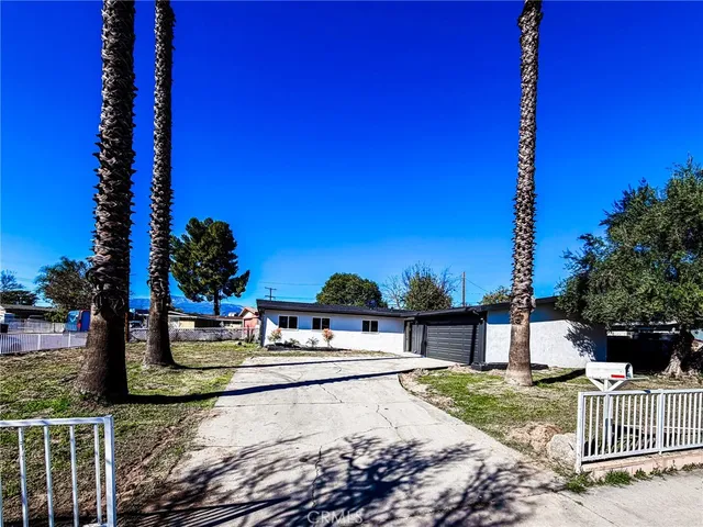 a view of a park with iron fence