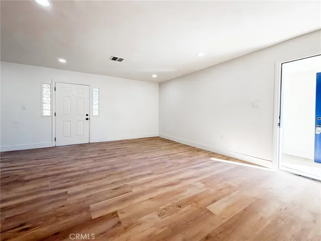 an empty room with wooden floor