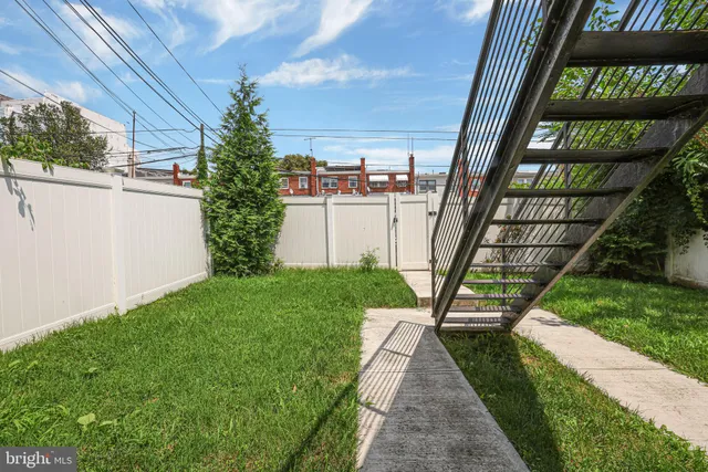 a view of a backyard with sitting area