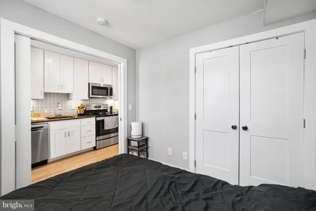 a kitchen with a refrigerator stove and white cabinets