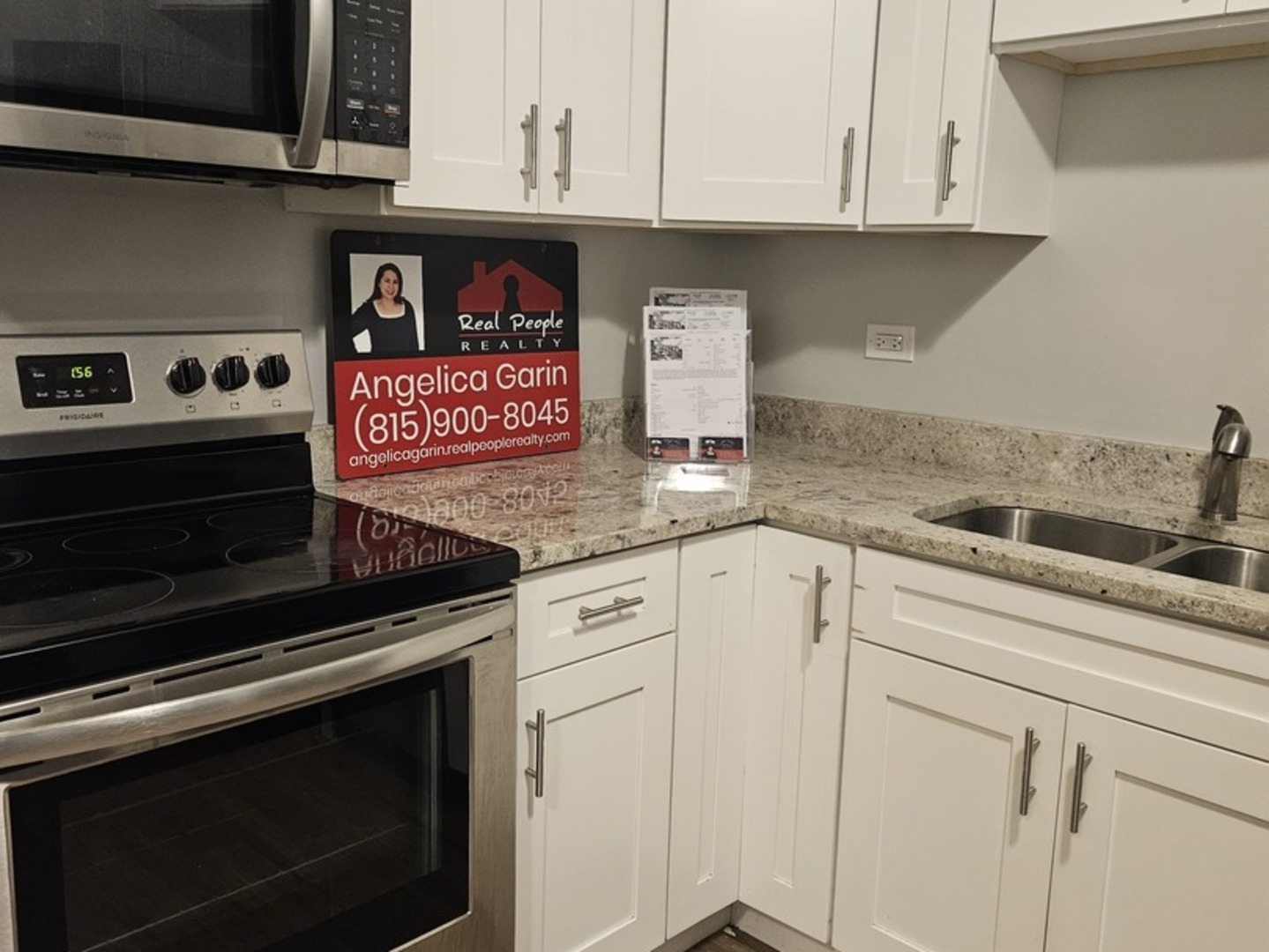 125 West Elk Trail, Unit 124 Carol Stream, IL 60188 - Photo 4 of 11 a kitchen with stainless steel appliances granite countertop white cabinets and stove