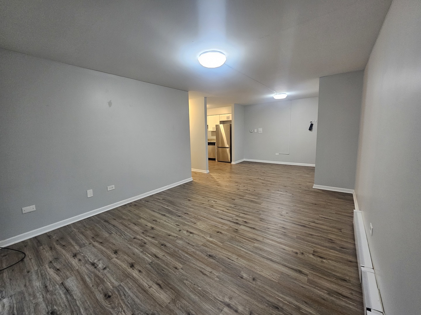 125 West Elk Trail, Unit 124 Carol Stream, IL 60188 - Photo 7 of 11 an empty room with wooden floor and windows