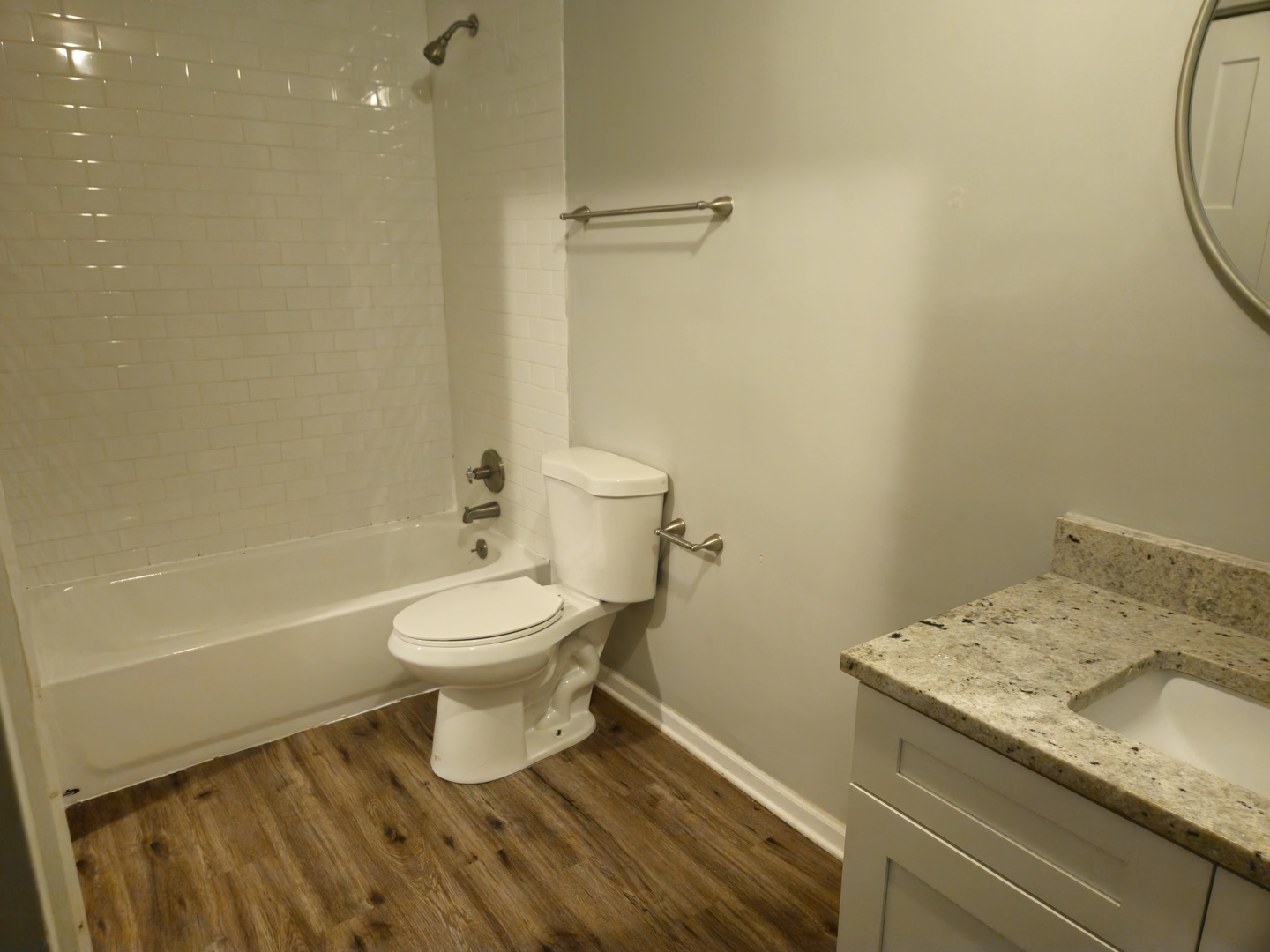 125 West Elk Trail, Unit 124 Carol Stream, IL 60188 - Photo 9 of 11 a bathroom with a granite countertop toilet and a sink