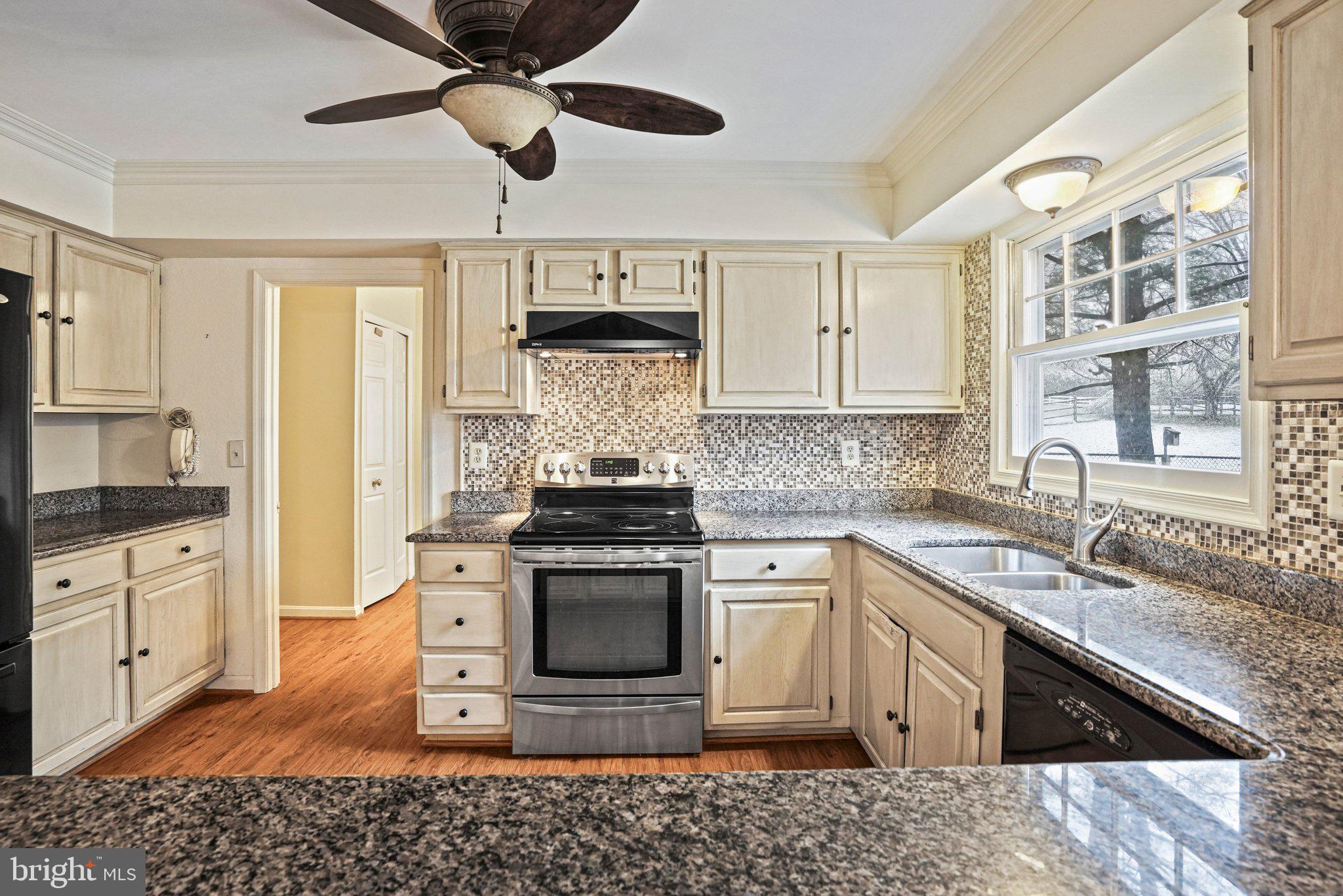 12737 Triple Crown Road Gaithersburg, MD 20878 - Photo 16 of 61 a kitchen with stainless steel appliances granite countertop a sink stove and refrigerator