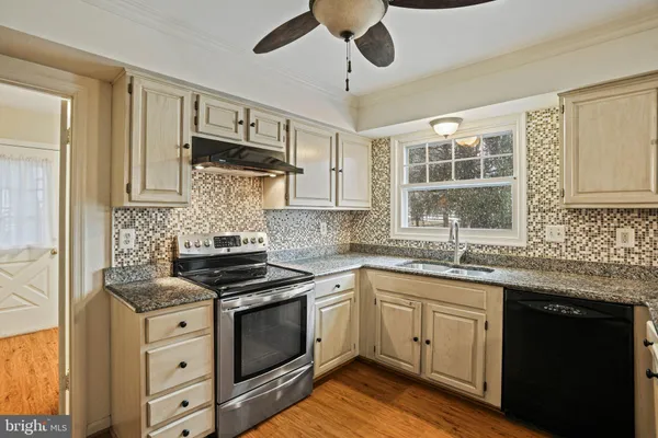 a view of utility room with wooden floor and windows