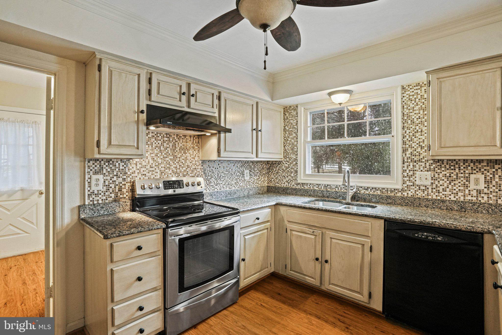 12737 Triple Crown Road Gaithersburg, MD 20878 - Photo 17 of 61 a kitchen with stainless steel appliances granite countertop a sink and cabinets