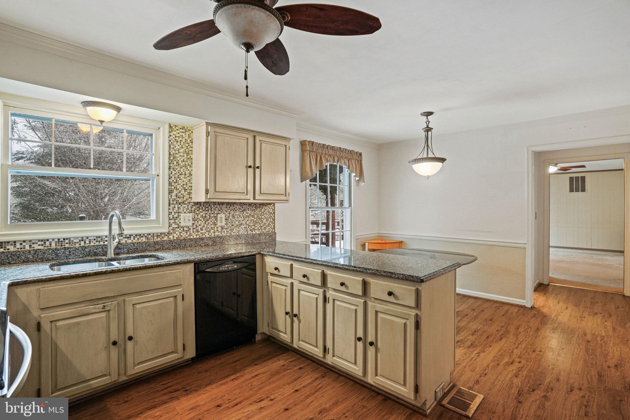 12737 Triple Crown Road Gaithersburg, MD 20878 - Photo 20 of 61 a kitchen with a sink window and cabinets