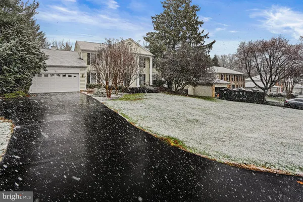 a view of residential houses with snow in the background