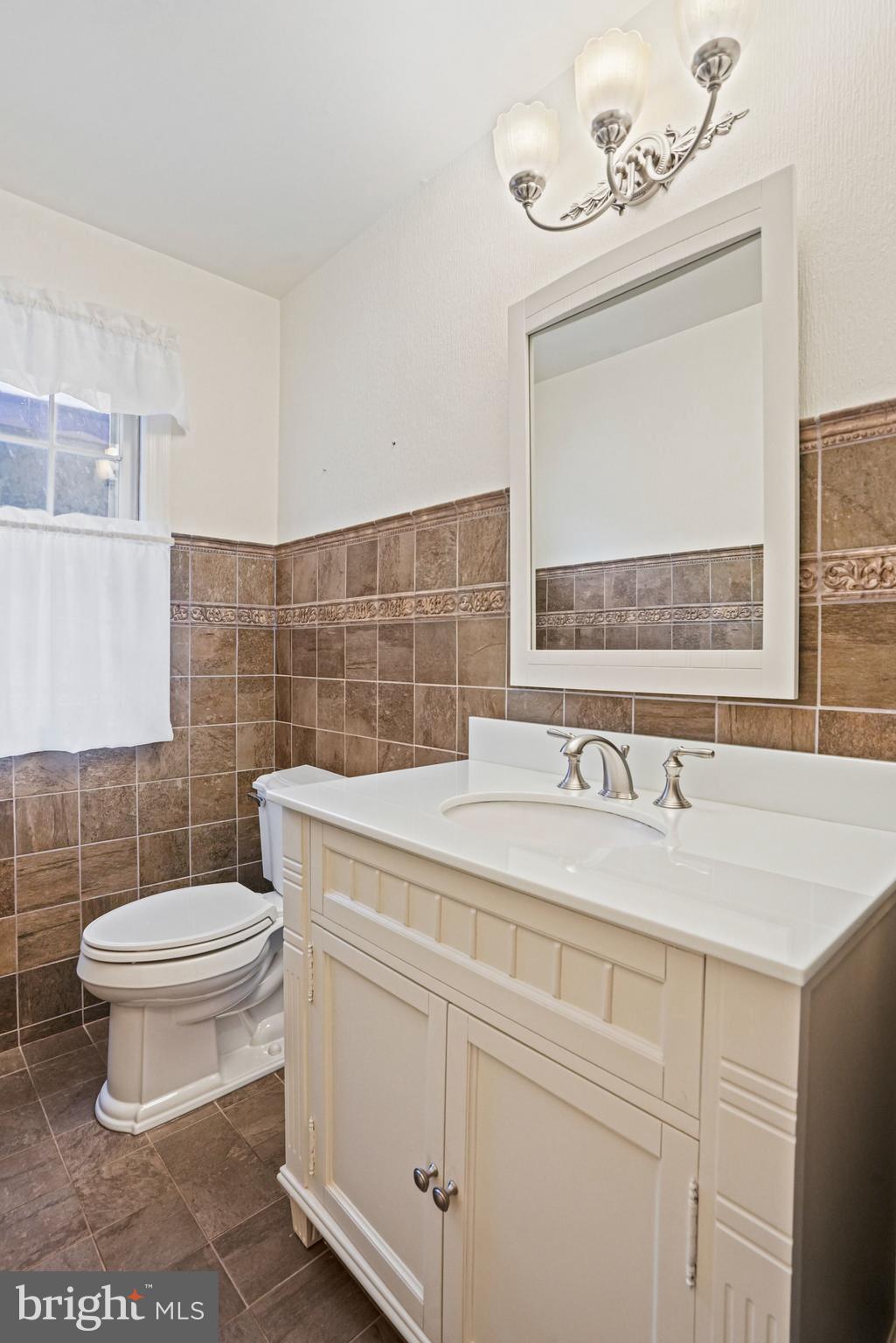 12737 Triple Crown Road Gaithersburg, MD 20878 - Photo 22 of 61 a bathroom with a granite countertop toilet sink and mirror