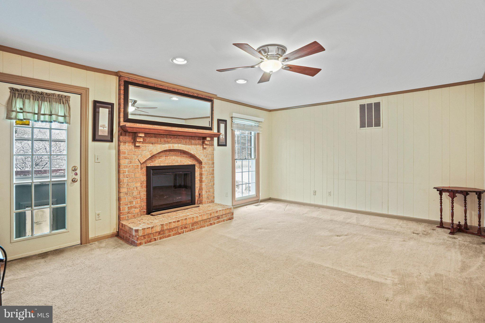 12737 Triple Crown Road Gaithersburg, MD 20878 - Photo 23 of 61 a view of an empty room with a fireplace and a window