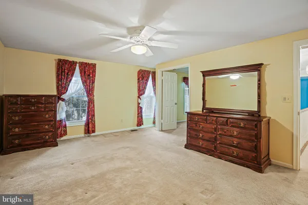 a living room with furniture and a air conditioner vent