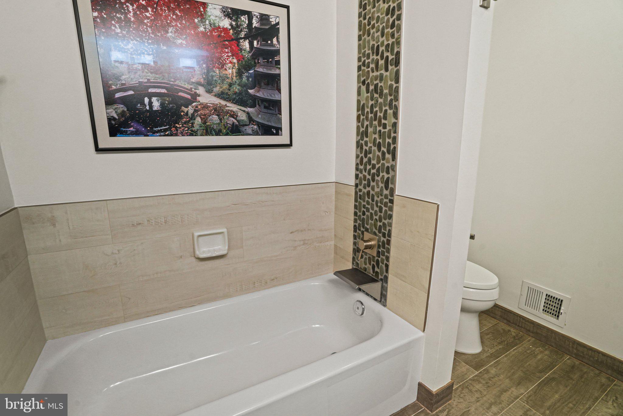 12737 Triple Crown Road Gaithersburg, MD 20878 - Photo 38 of 61 a view of a bathtub in a bathroom