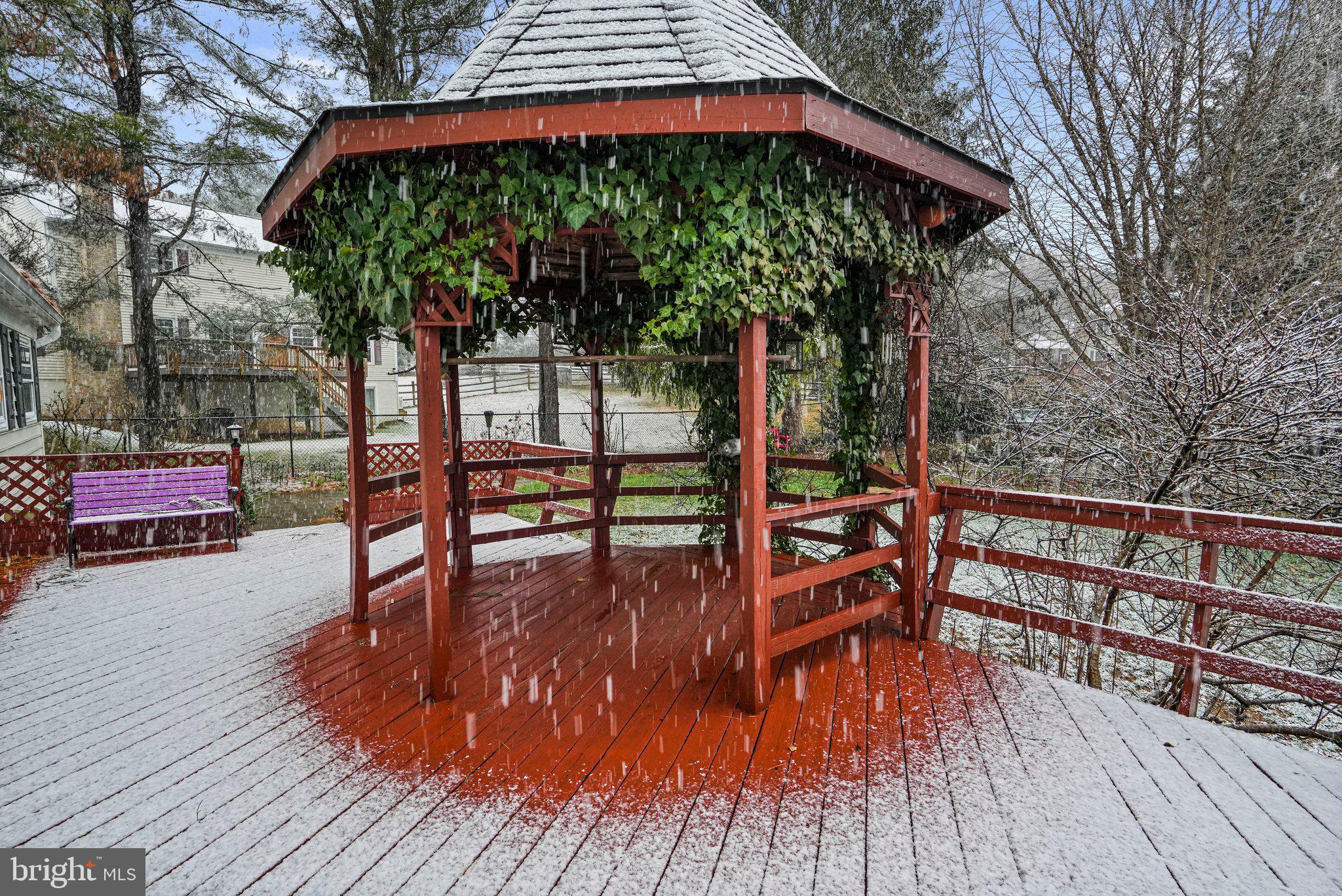 12737 Triple Crown Road Gaithersburg, MD 20878 - Photo 50 of 61 a view of a deck with wooden floor and outdoor seating