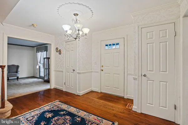 a spacious bedroom with a bed a couch and large window