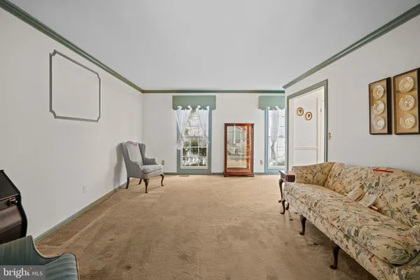 a view of a room with a piano and wooden floor