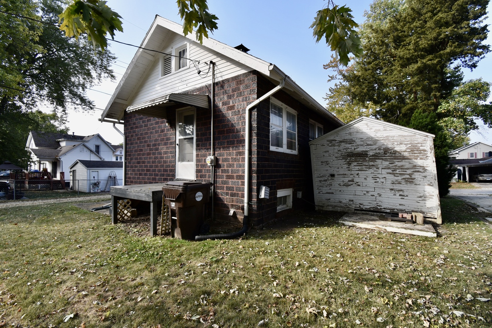 116 North Maple Street Clinton, IL 61727 - Photo 3 of 14 a view of a house that has a small yard and large trees