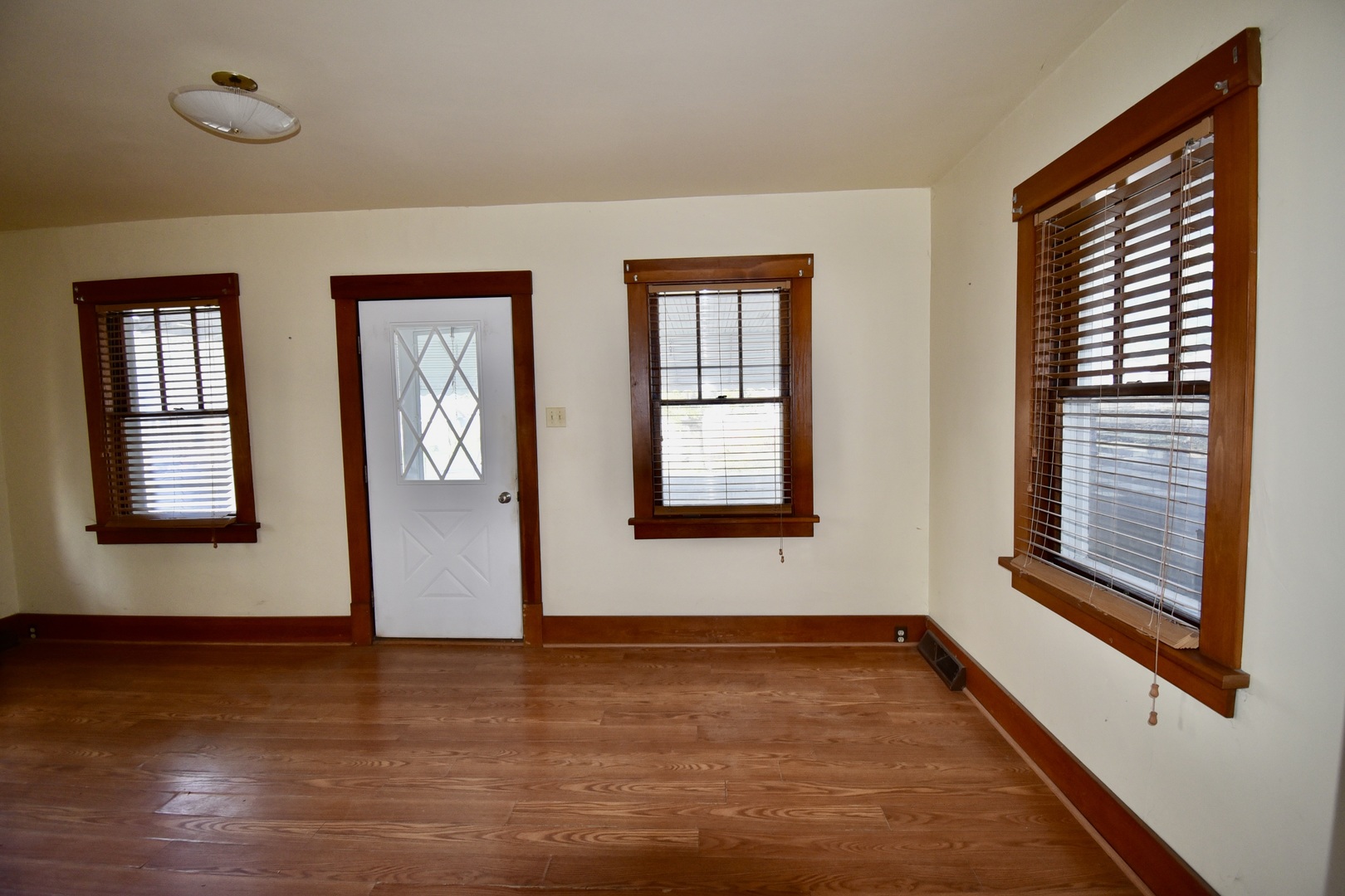116 North Maple Street Clinton, IL 61727 - Photo 6 of 14 a view of an empty room with wooden floor and a window