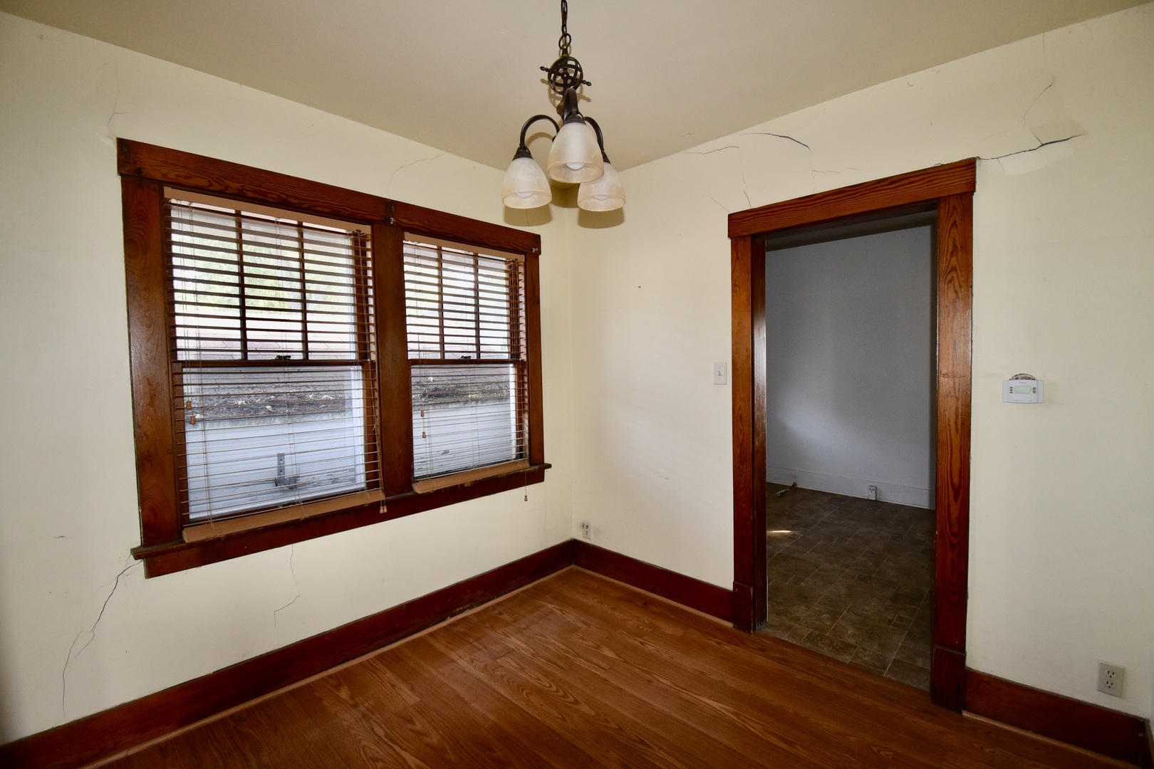 116 North Maple Street Clinton, IL 61727 - Photo 7 of 14 a view of an empty room with wooden floor and a window