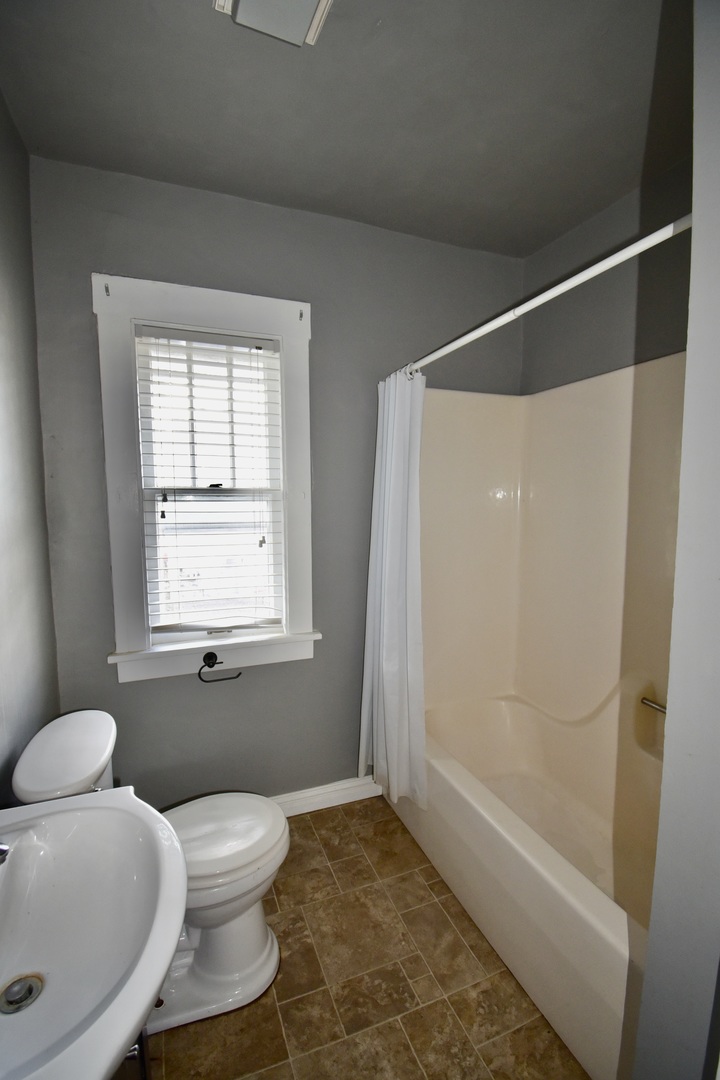 116 North Maple Street Clinton, IL 61727 - Photo 8 of 14 a bathroom with a toilet and a shower