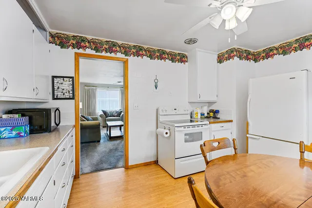 a kitchen with a refrigerator a stove top oven a sink and dishwasher