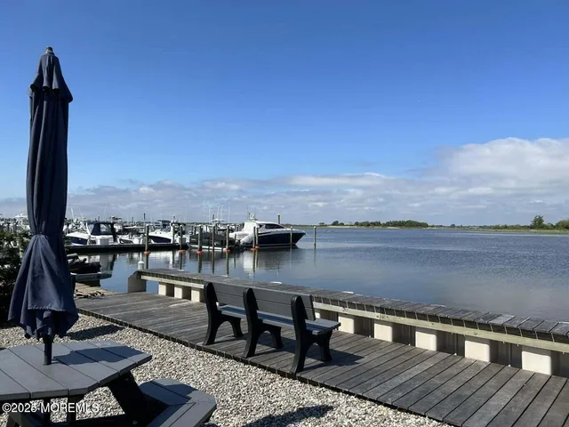 a view of a lake with couches and city view
