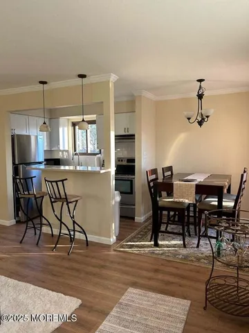 a view of a dining room with furniture and a table