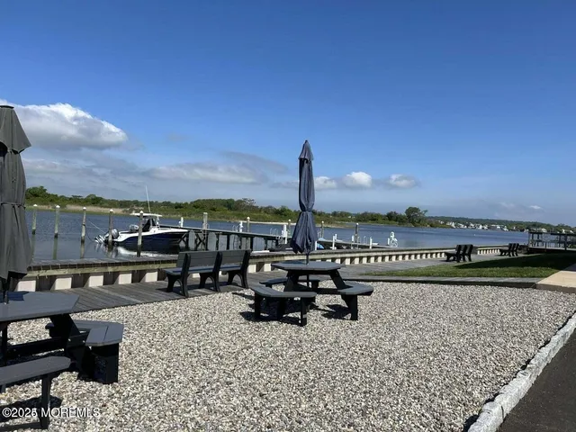a terrace with a bench and lake view